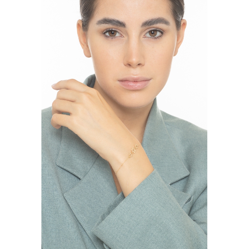 Pulsera en oro amarillo 18 quilates con tres flores  Pulsera en oro amarillo 18 quilates con tres flores