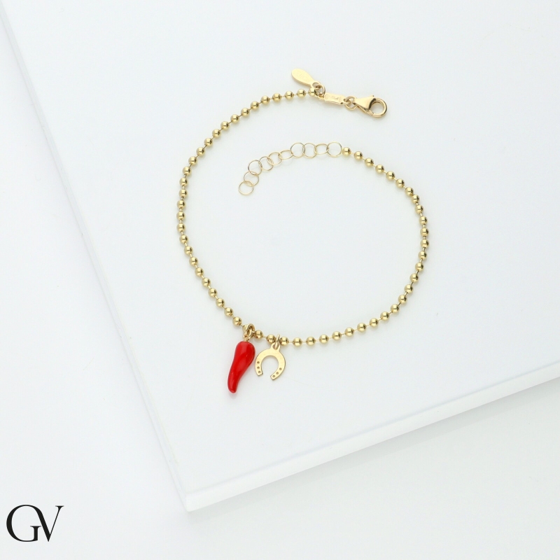Pulsera oro 18K con herradura y cuerno rojo de la suerte