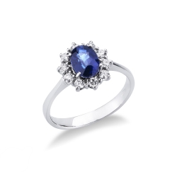 Anillo de oro blanco 18k con zafiro azul ovalado y halo de diamantes