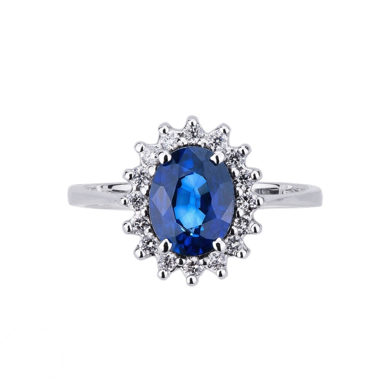 Anillo de oro blanco de 18 kilates con zafiro azul central y halo de diamantes  Anillo de oro blanco de 18 kilates con zafiro azul central y halo de diamantes