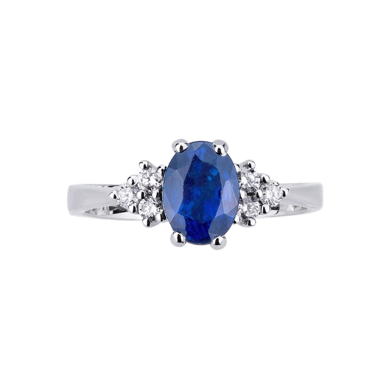 Anillo en oro blanco de 18k con diamantes laterales y zafiro azul Anillo en oro blanco de 18k con diamantes laterales y zafiro azul