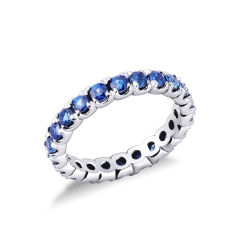 Anillo modelo eternidad con zafiro azul y oro blanco de 18 kilates