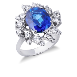 Anillo halo en oro blanco de 18k con un zafiro azul talla ovalada y diamantes