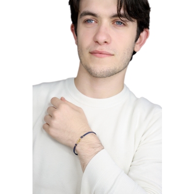 Pulsera de tela azul con nudo central en oro amarillo 18k